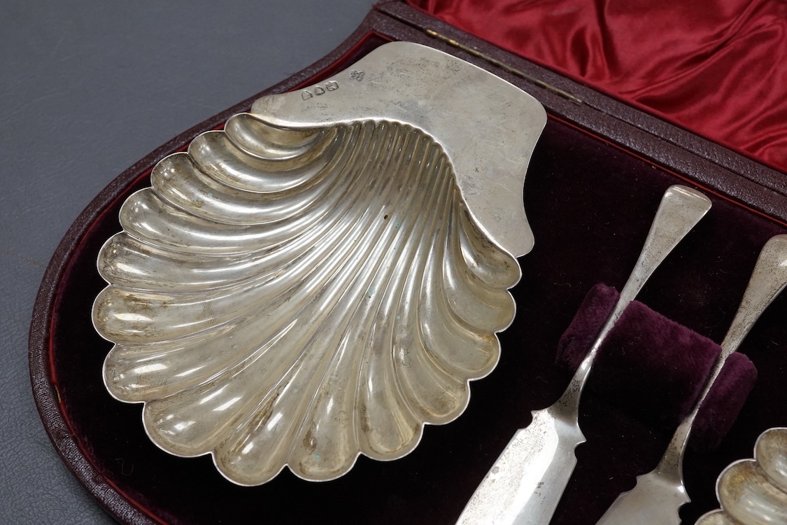 A late Victorian cased pair of silver butter shells and matching butter knives, by Horace Woodward & Co Ltd, London, 1894/5, shell 12.9cm, 5.6oz.